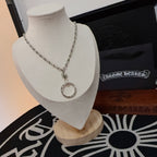 Silver-tone ring pendant necklace on a mannequin bust with chain and clasp detail.
