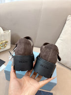 Prada women’s suede shoes, brown, heel view with rear Prada lettering.