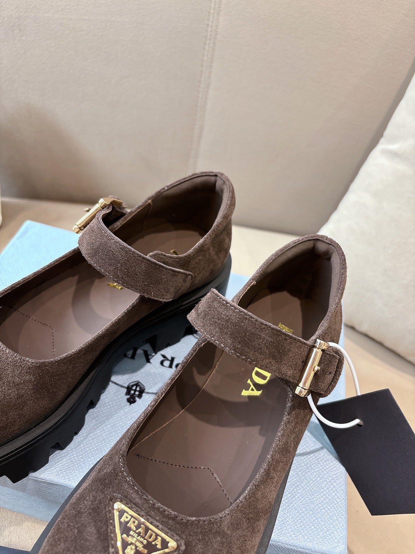 Prada women’s suede buckle flats, brown, view of interior lining and strap.