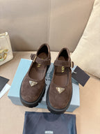 Prada women’s suede buckle shoes with triangular logo, brown, chunky sole.