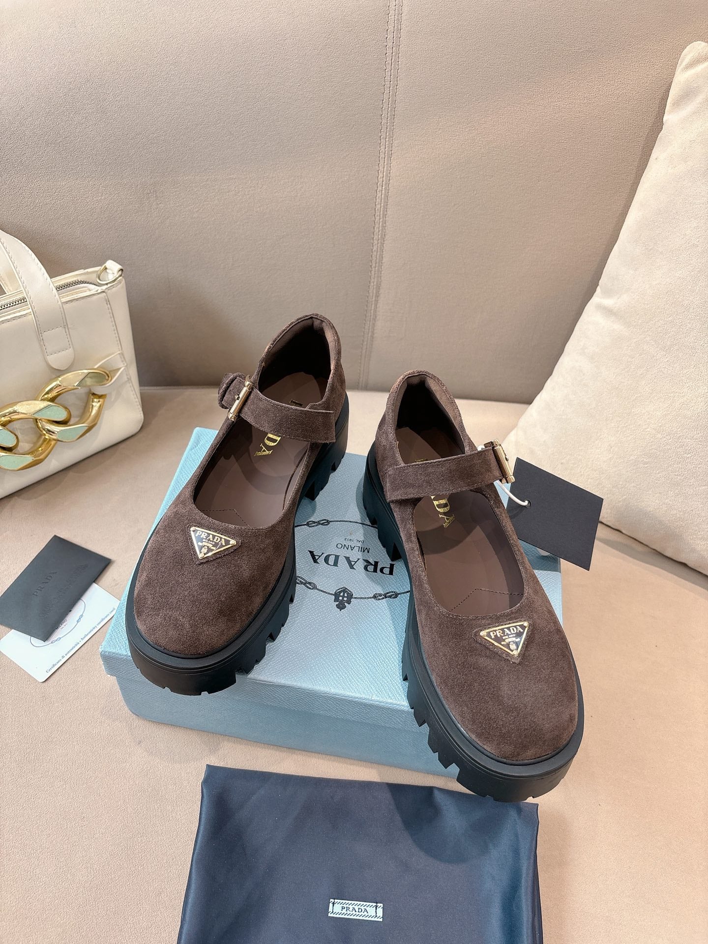 Prada women’s suede buckle shoes, brown, two-tone chunky outsole detail.