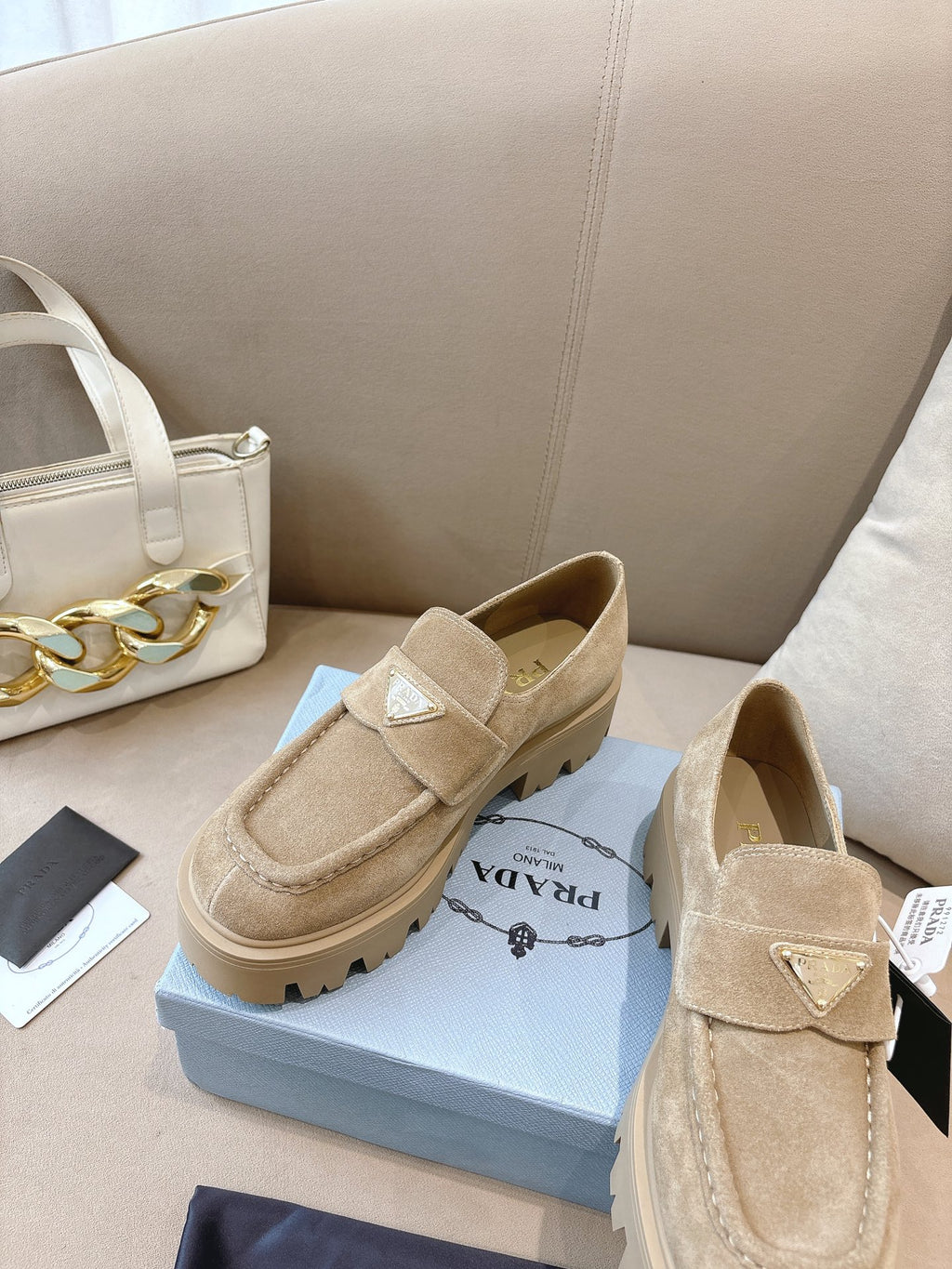 Beige suede loafer mules with strap, cushioned back and lug sole, Prada
