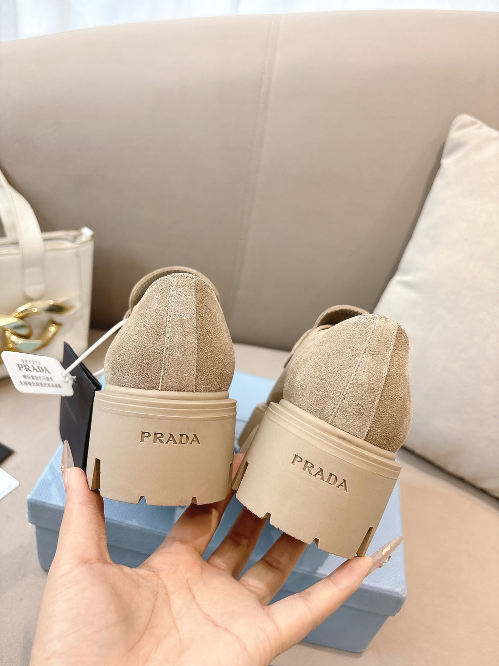 Beige suede loafer mules with strap and Prada heel label