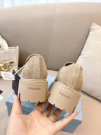 Beige suede loafer mules with strap and Prada heel label