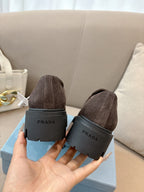 Dark brown suede loafers, heel view with logo print on rubber sole block