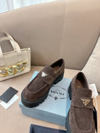Suede loafers, dark brown slip-on style with logo plaque and lug sole