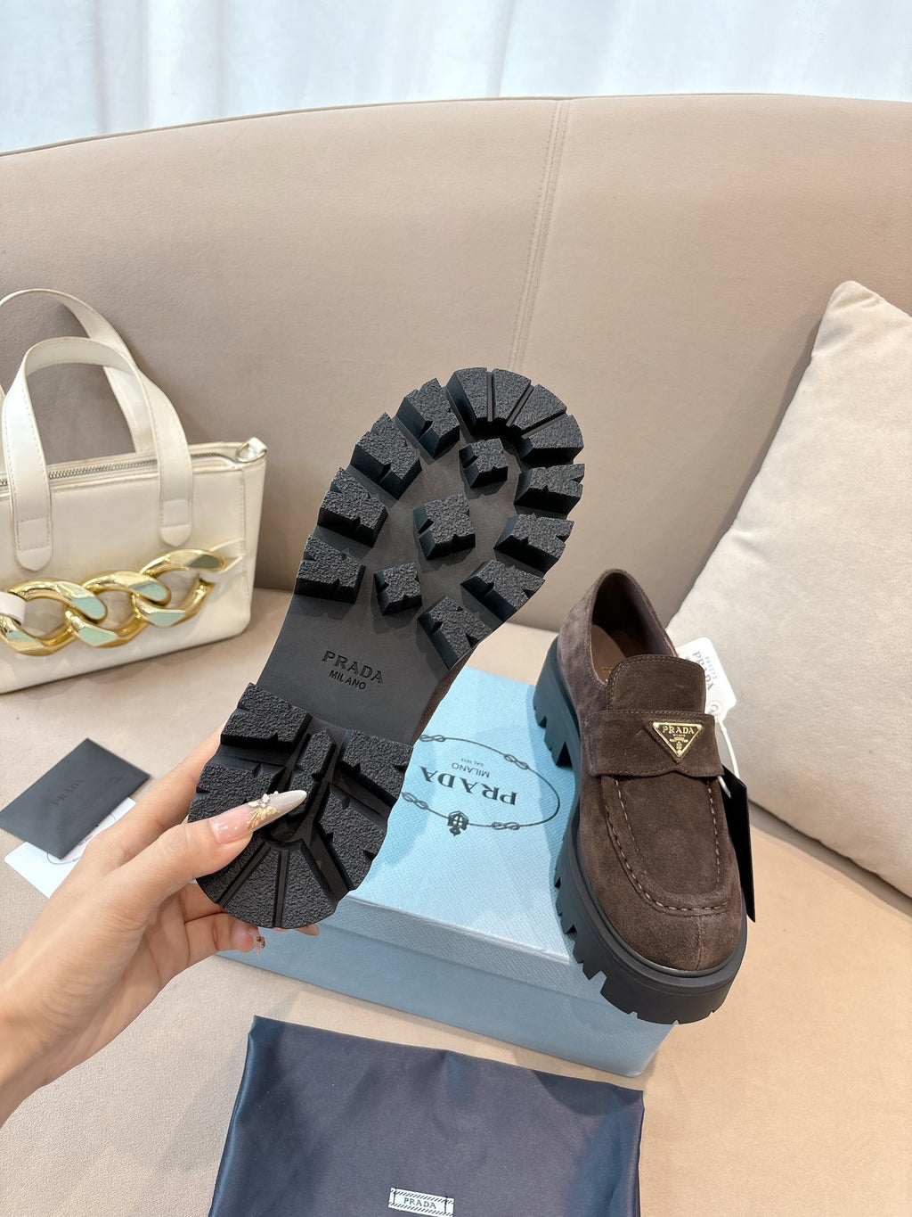 Dark brown suede loafers, outsole view with tread and strap detail