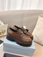 Prada ladies brown leather loafers with wide strap and logo plaque on chunky tread sole