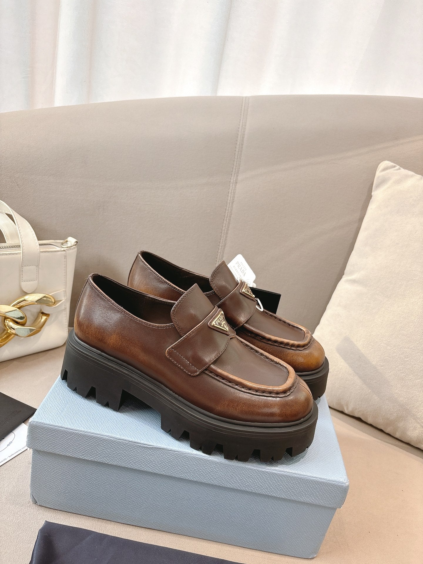 Prada ladies brown leather loafers with wide strap and logo plaque on chunky tread sole