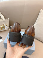 Prada ladies brown leather loafers, back view with PRADA heel tab on lug sole