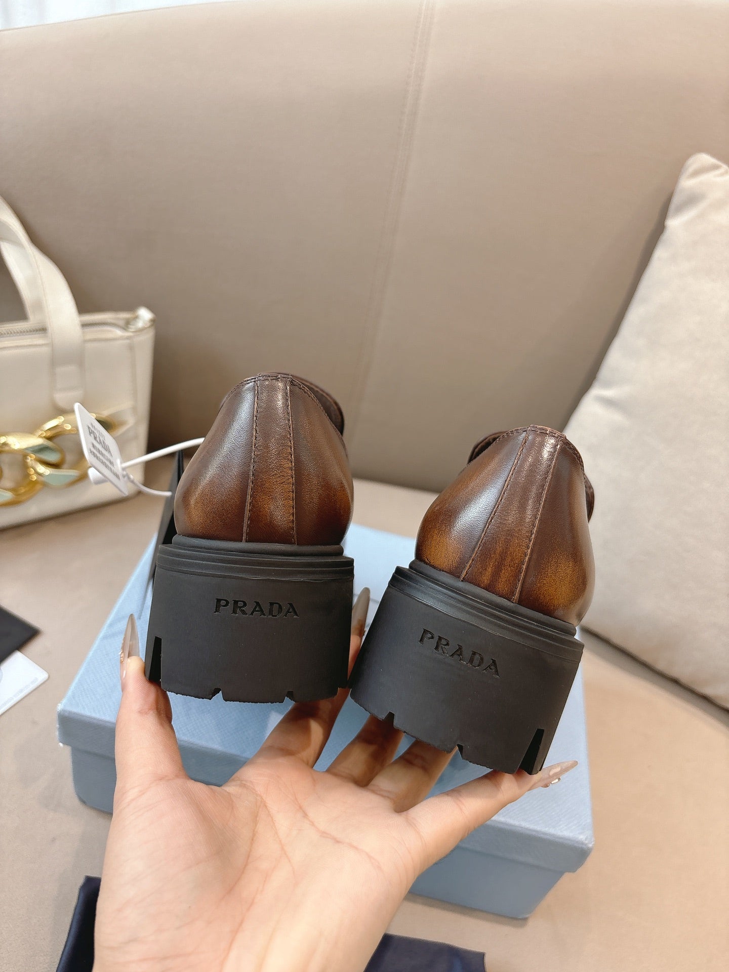 Prada ladies brown leather loafers, back view with PRADA heel tab on lug sole
