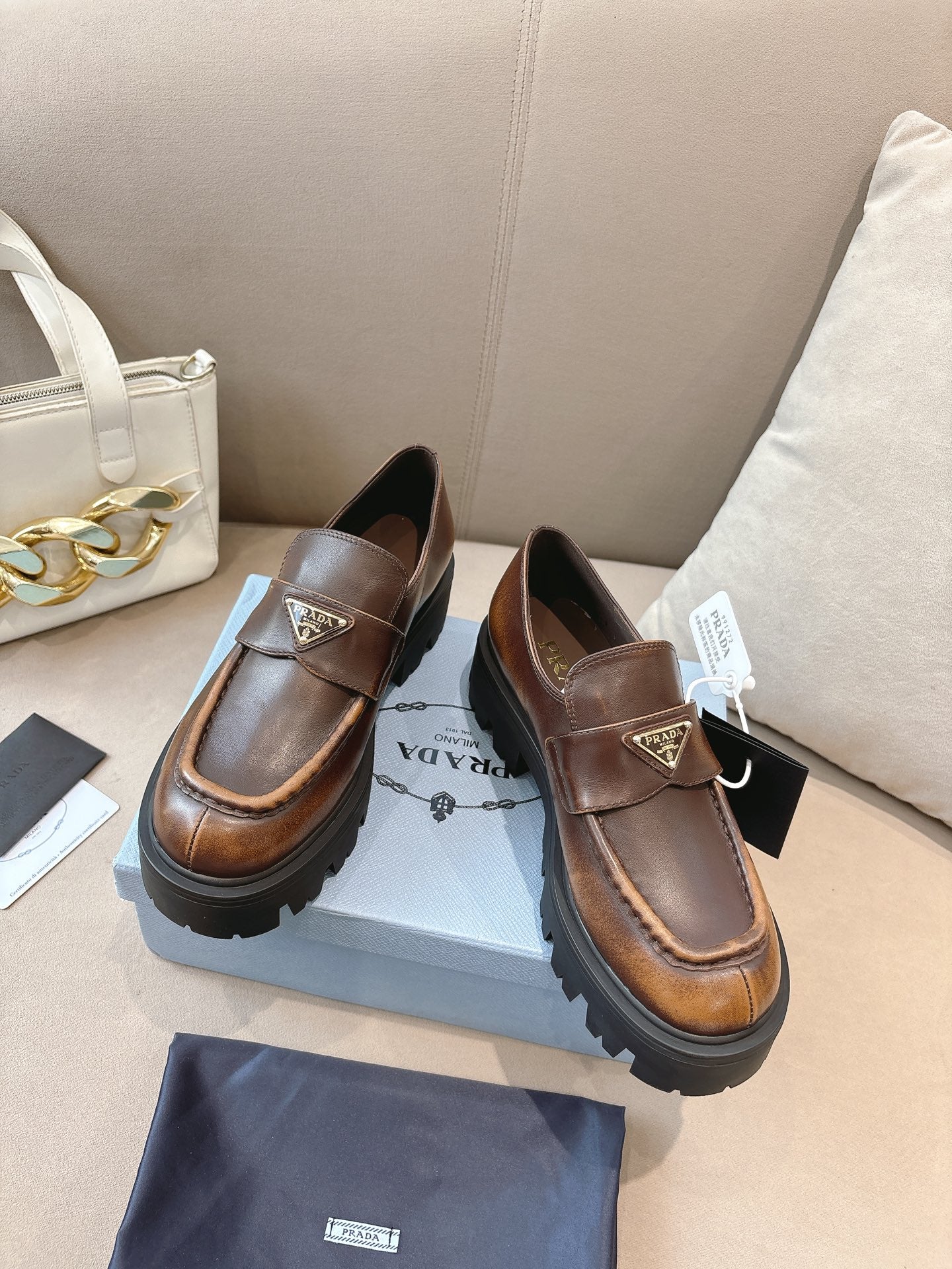 Prada ladies brown leather loafers, square logo plaque on strap, thick lug outsole