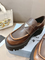 Prada ladies brown leather loafer with square logo plaque on strap and molded lug sole