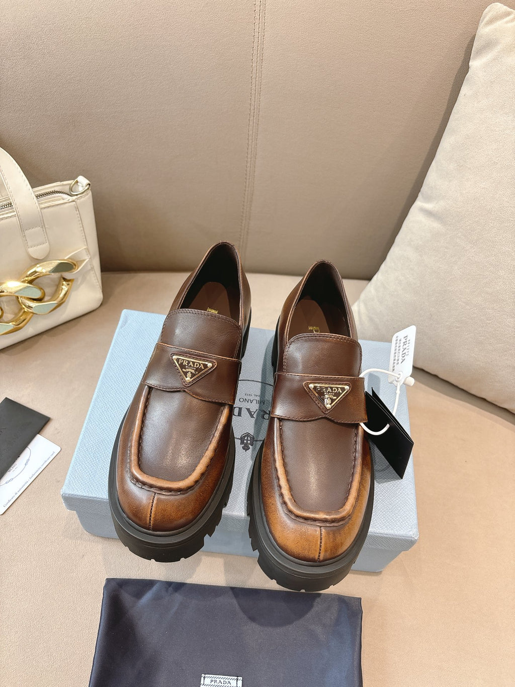 Prada ladies brown leather loafers with buckle strap, logo plaque, chunky lug sole