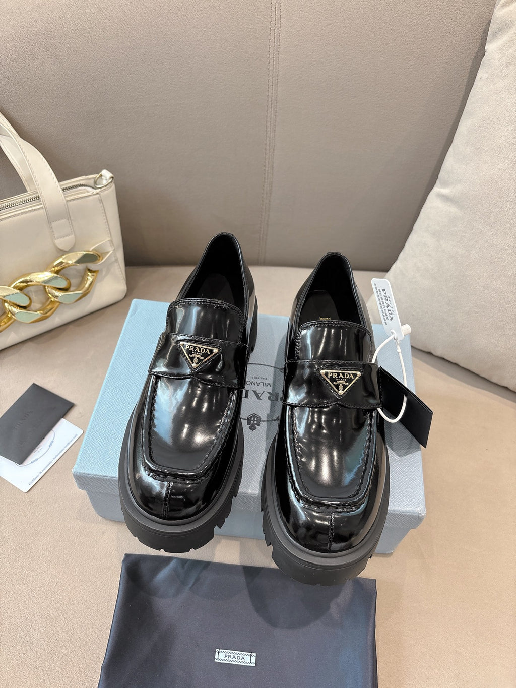 Prada ladies black patent loafers with front buckle strap and chunky platform sole