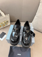 Prada ladies black patent loafers with front buckle strap and chunky platform sole
