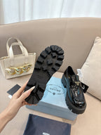 Prada ladies black loafer outsole tread and heel view; shoes with chunky lug sole