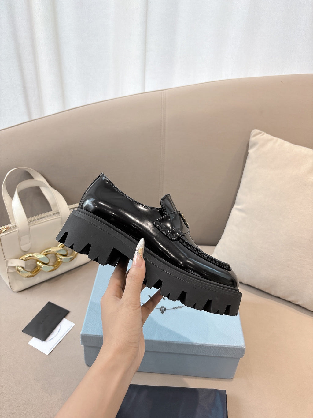 Prada ladies black patent loafer with platform sole and front buckle strap detail