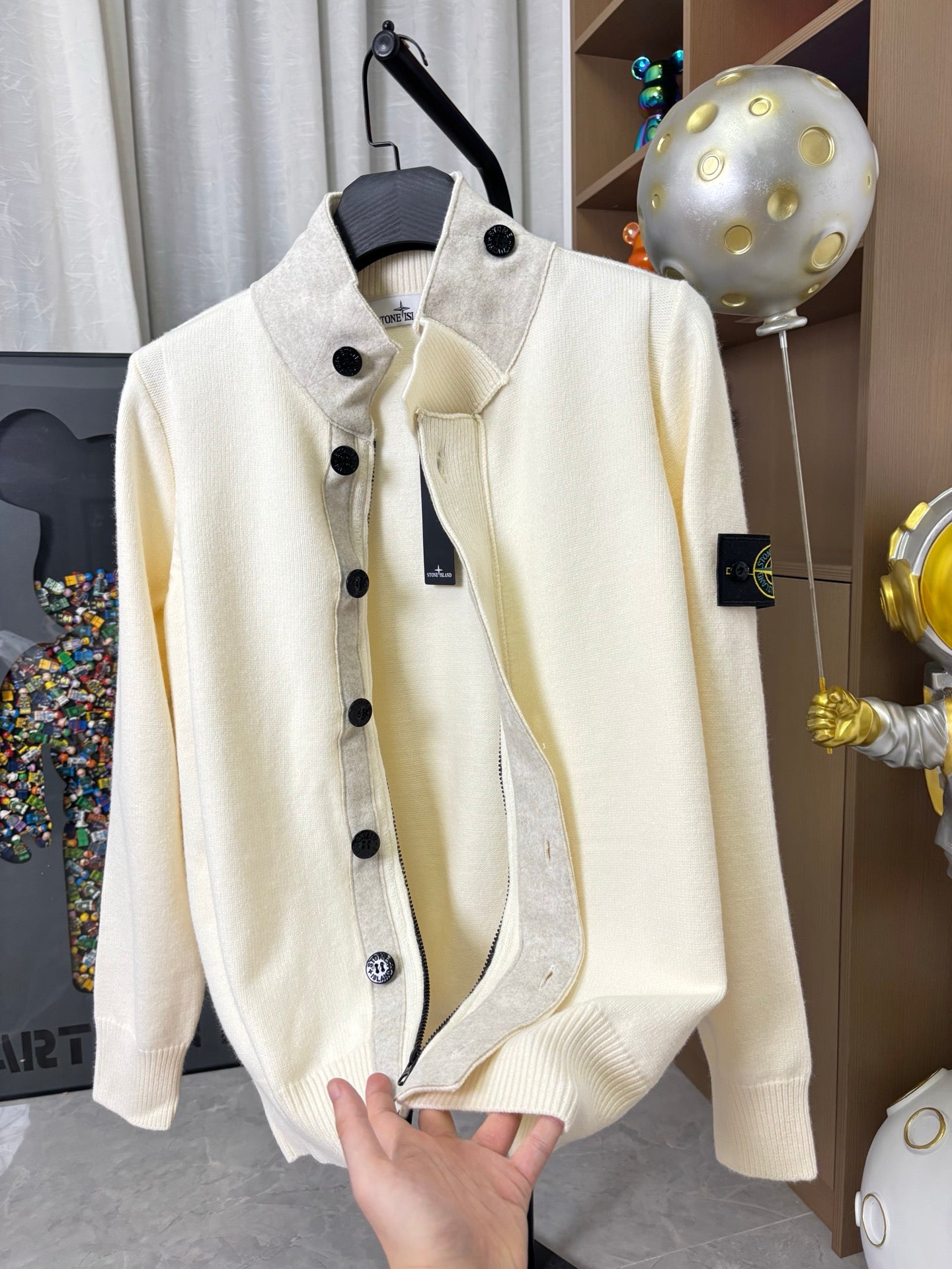 Stone Island knit cardigan, cream color, front view with stand collar and black buttons