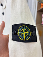 Stone Island logo patch on cream knit cardigan sleeve cuff with black trim