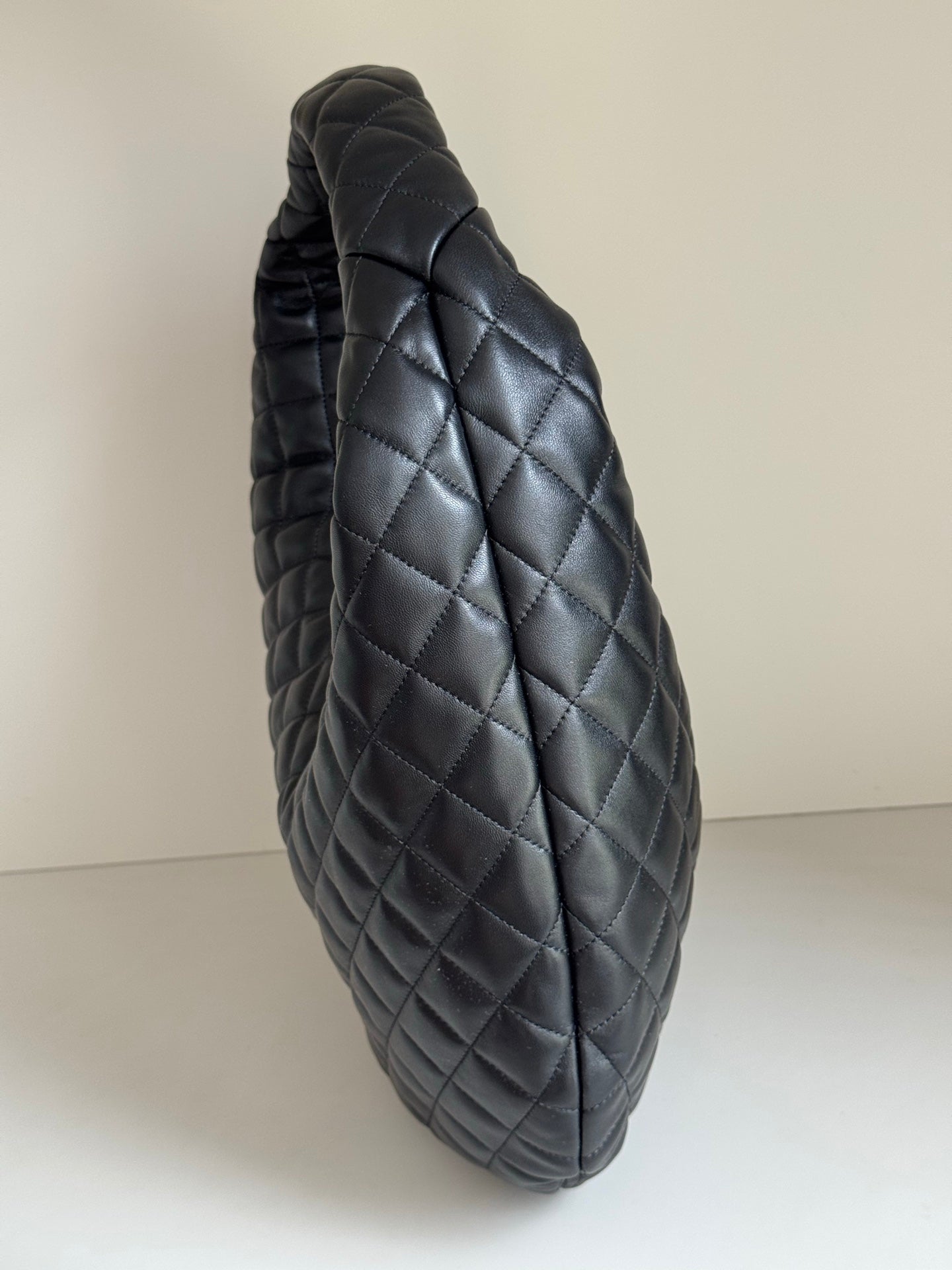 YSL quilted hobo bag back view with diamond pattern, dark leather-look