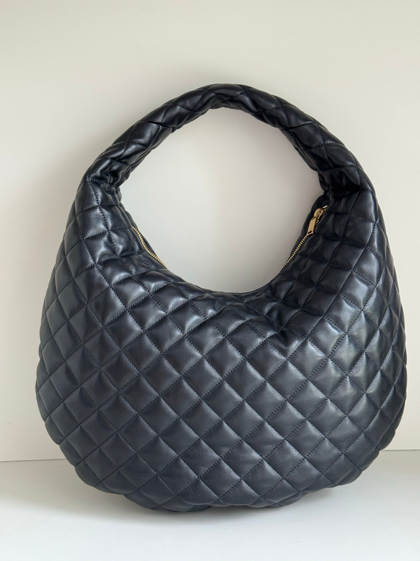 YSL quilted hobo bag with diamond stitching, dark leather-look, curved handle