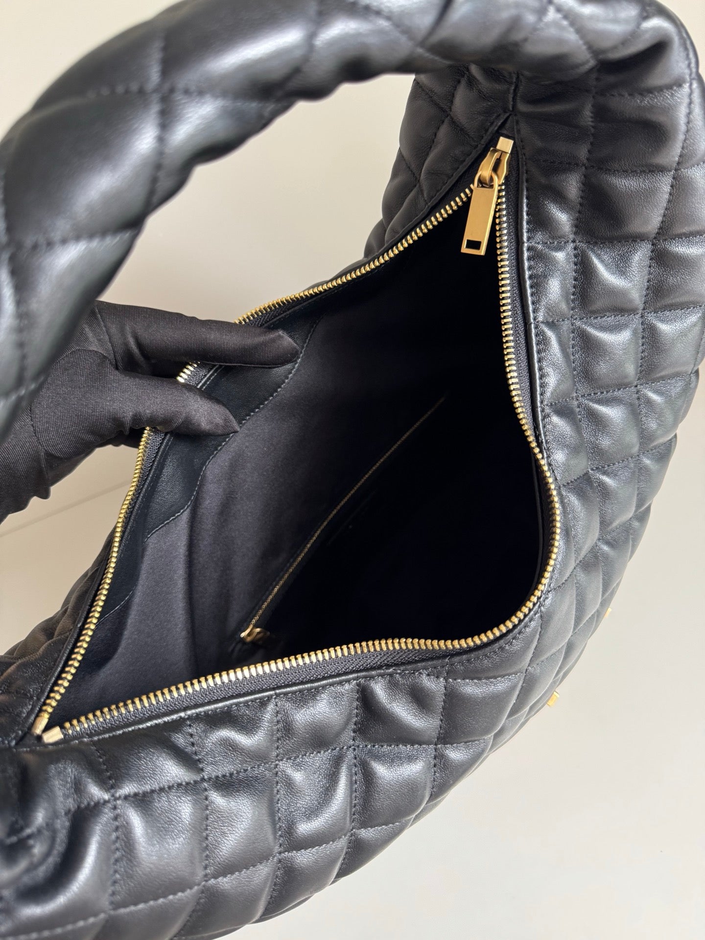 YSL quilted hobo bag open top with black lining and gold zipper hardware