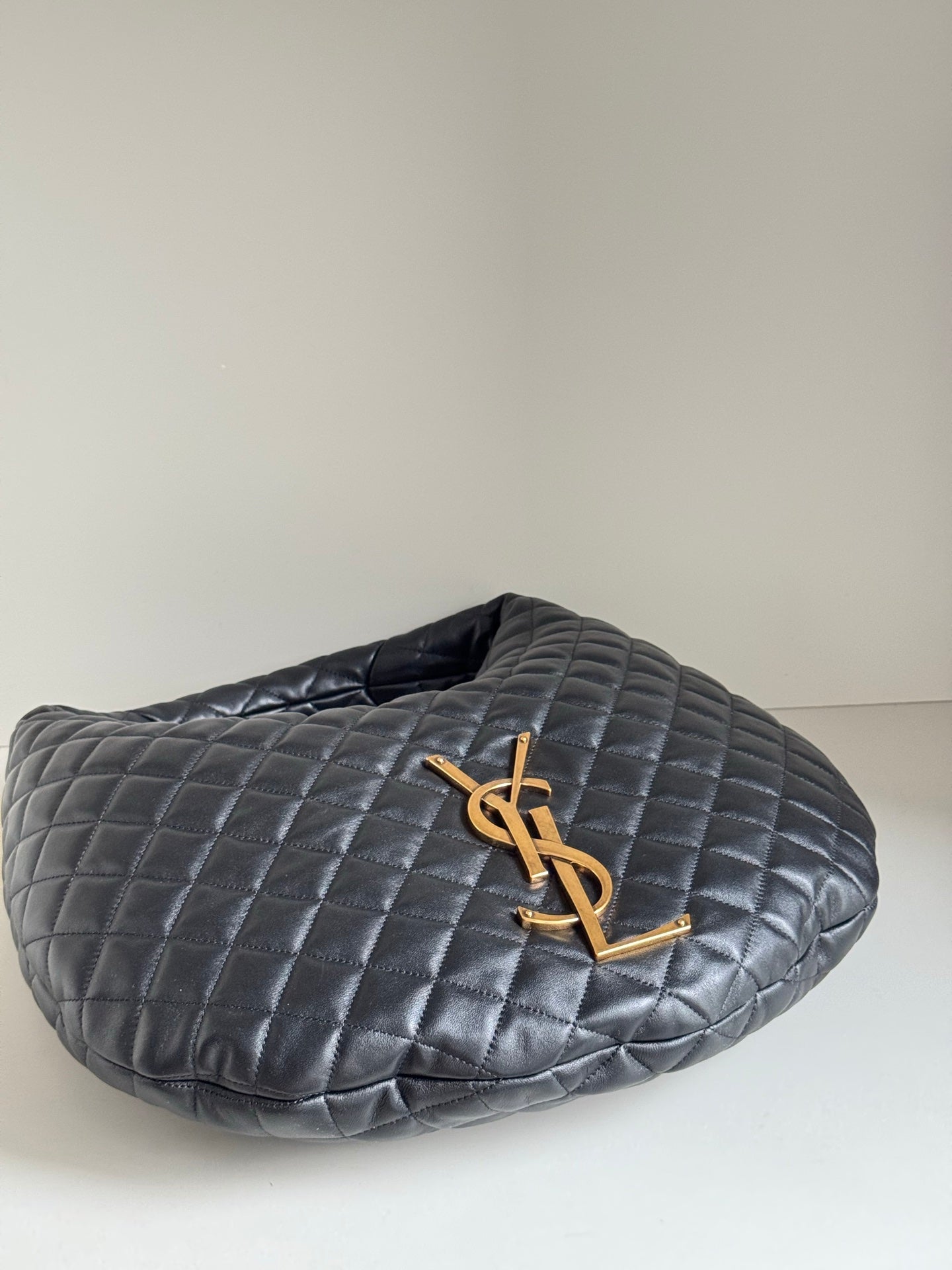YSL quilted hobo bag top view with gold YSL logo, dark leather-look