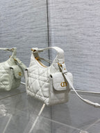 White quilted Dior mini shoulder bag with gold logo plate and adjustable crossbody strap.