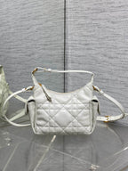 White quilted Dior shoulder bag with crossbody strap and gold-tone hardware, front view.