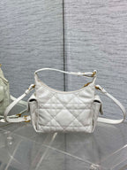 White quilted Dior mini shoulder bag with long crossbody strap and gold top hardware.