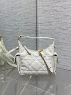 White quilted Dior shoulder bag with top handle and gold hardware, short strap.