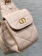 Dior quilted light pink bag front flap with gold D emblem and rounded pocket opening