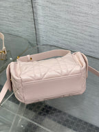 Dior quilted light pink shoulder bag with curved top and side strap attachment points