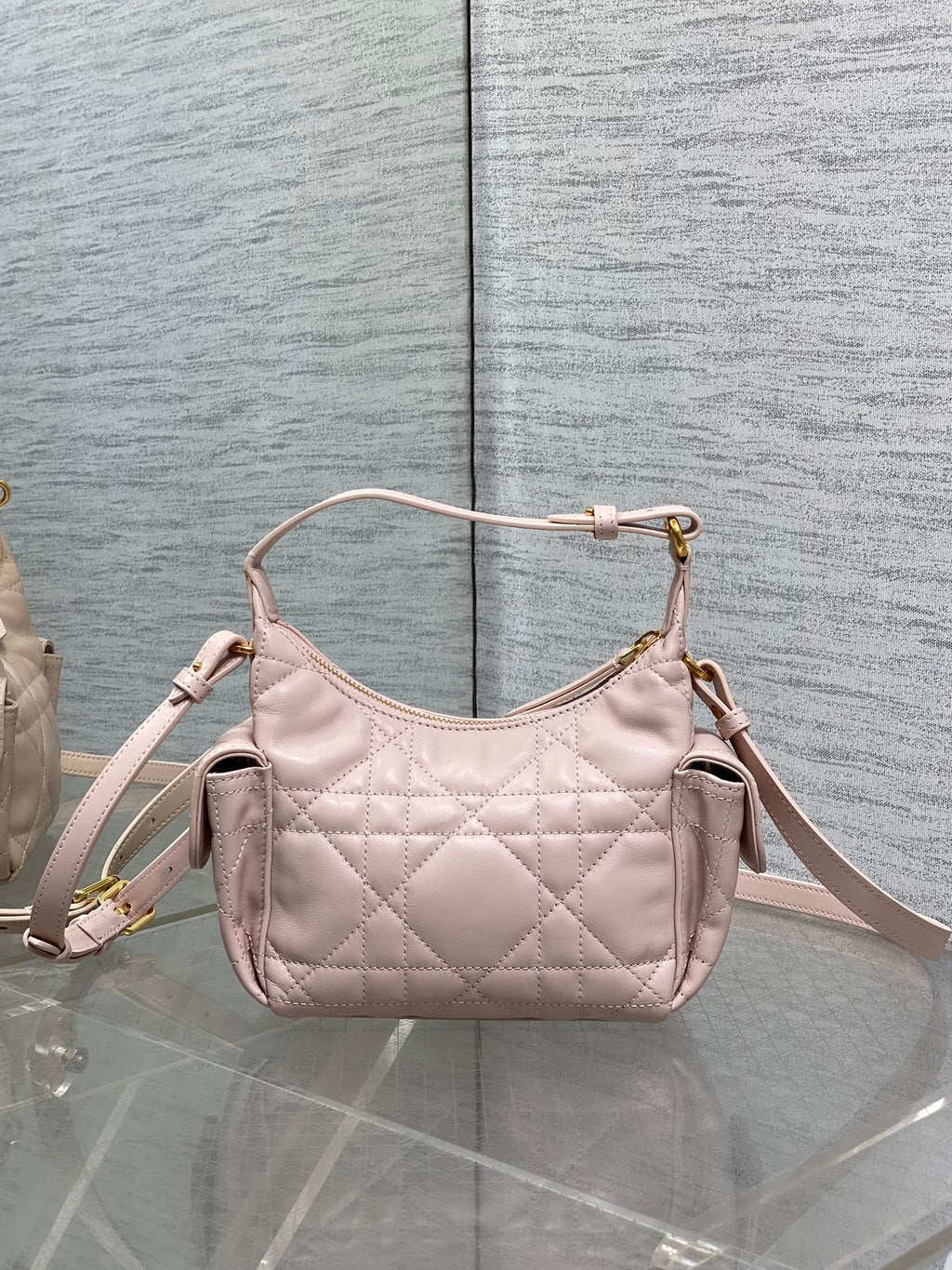 Dior quilted light pink crossbody hobo bag with top handle loop and gold hardware