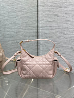 Dior quilted light pink hobo bag with two top handles, side gussets, and gold trim