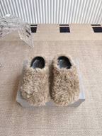 Balenciaga fuzzy beige slide sandals with black toe openings, on a box