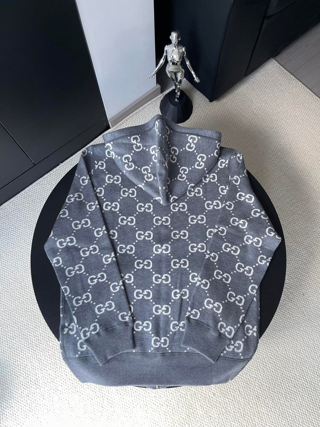 Gucci zip-up hoodie in dark gray with repeating GG logo print, front view