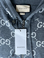 Gucci zip-up hoodie neckline close-up with GUCCI tag and front zipper hardware
