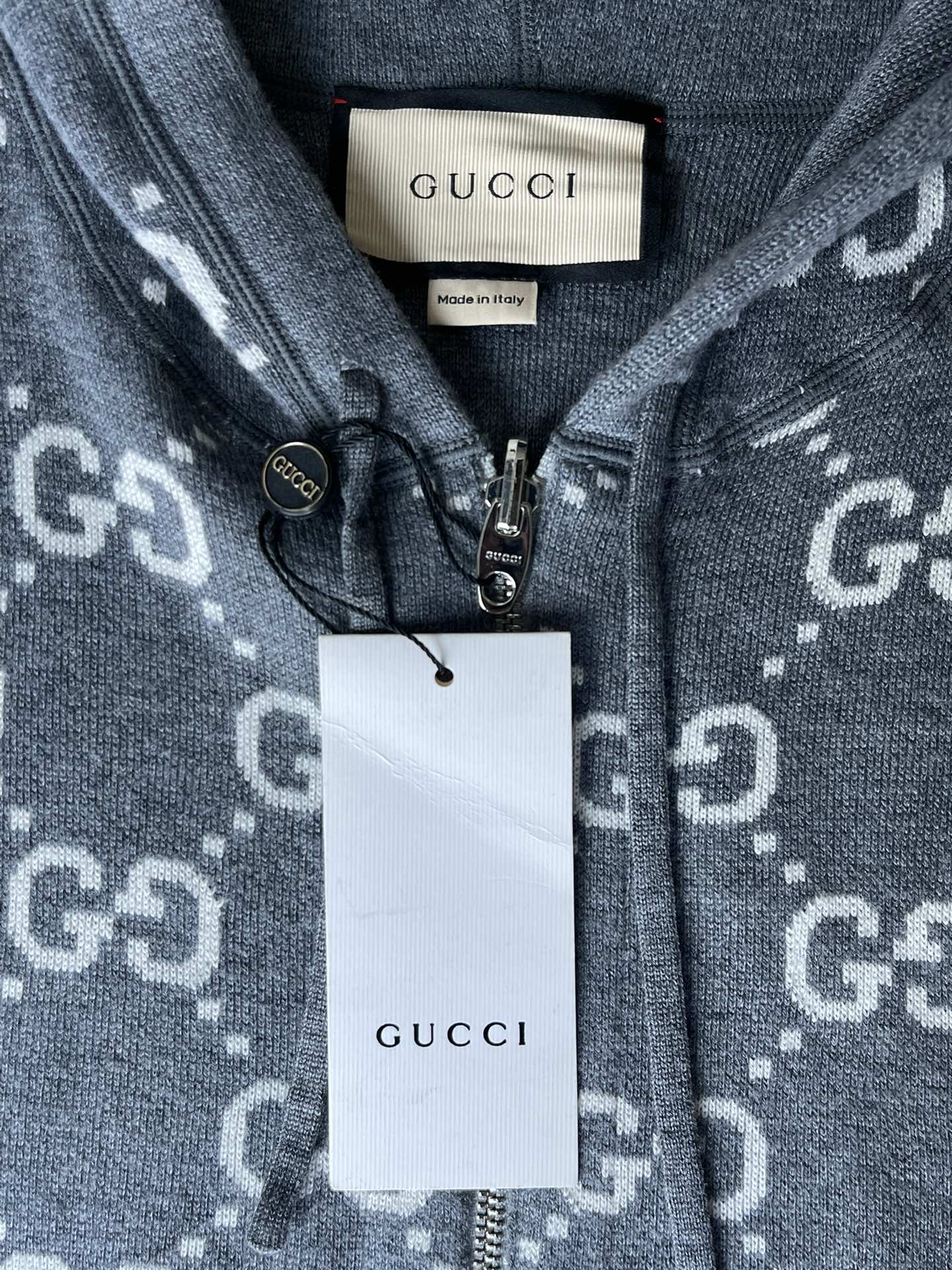 Gucci zip-up hoodie neckline close-up with GUCCI tag and front zipper hardware