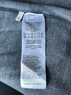 Inside size label on Gucci zip-up hoodie fabric, with care and fabric details