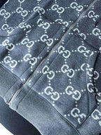 Gucci GG logo zip-up hoodie close-up showing zipper trim and drawcord hood edge