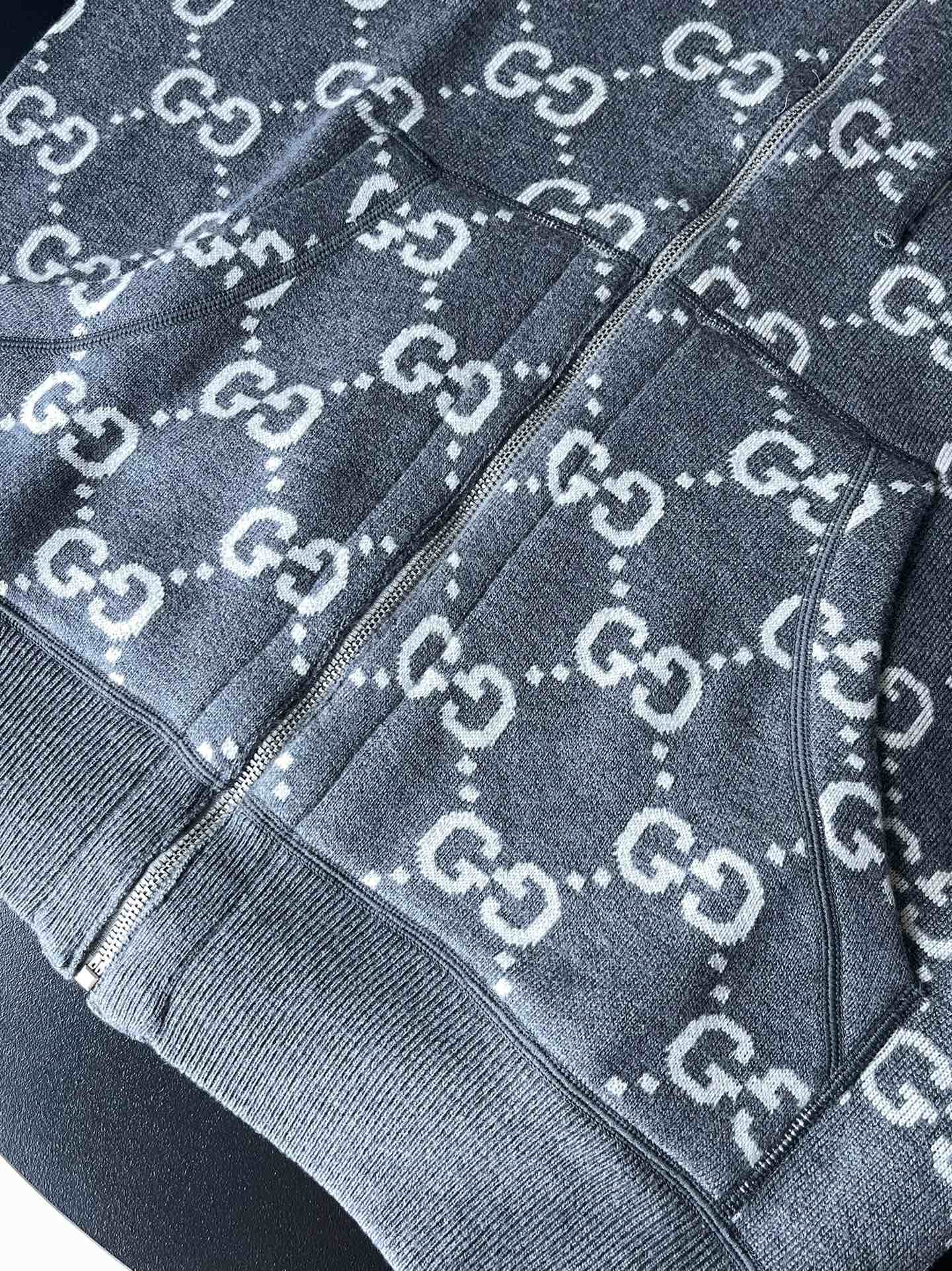 Gucci GG logo zip-up hoodie close-up showing zipper trim and drawcord hood edge