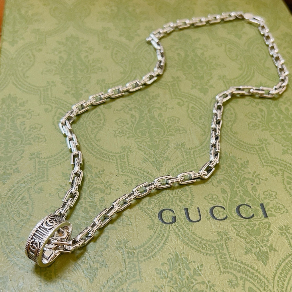 Silver-tone chain necklace with Gucci logo charm and oval link pendant