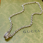 Silver-tone chain necklace with Gucci logo charm and oval link pendant
