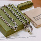 Silver-tone chain necklace with large oval Gucci clasp pendant