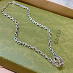 Silver-tone Gucci chain necklace with oval logo charm and clasp