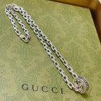 Silver-tone long chain necklace with oval logo medallion pendant