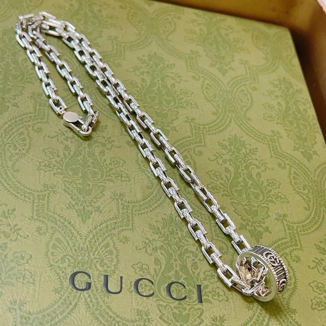 Silver-tone long chain necklace with oval logo medallion pendant