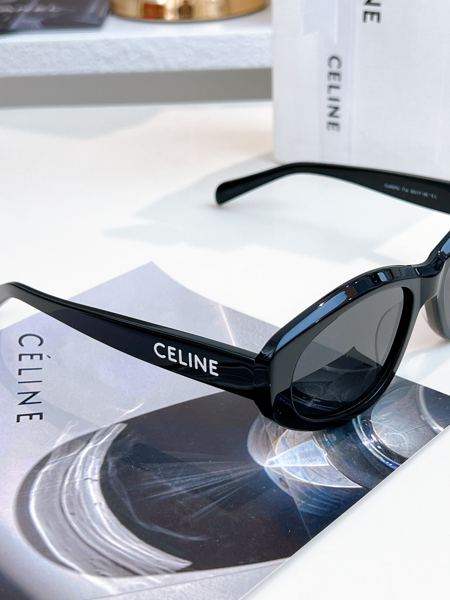Sunglasses with black frame and dark lenses, tilted view